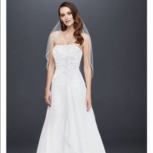 White wedding dress with tags from David’s Bridal